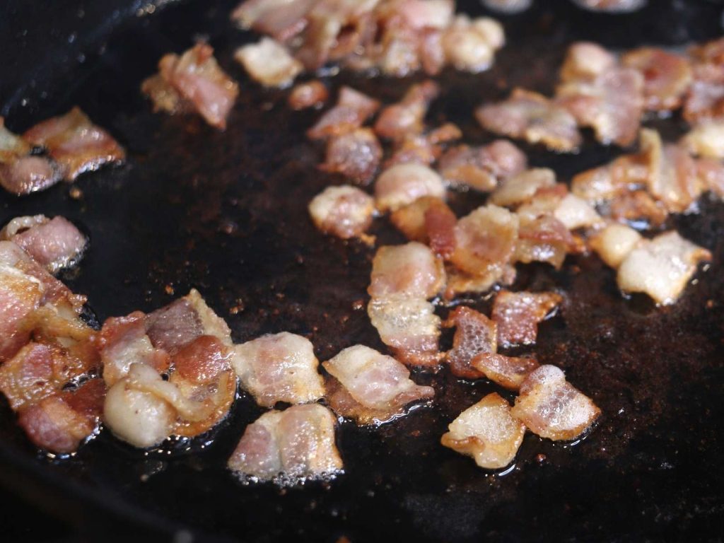 bacon pieces in cast iron skillet