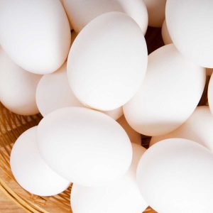 wicker basket of white chicken eggs