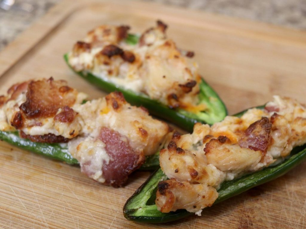 up close shot of cooked  air fryer jalapeno poppers stuffed with bacon, chicken, and cheese