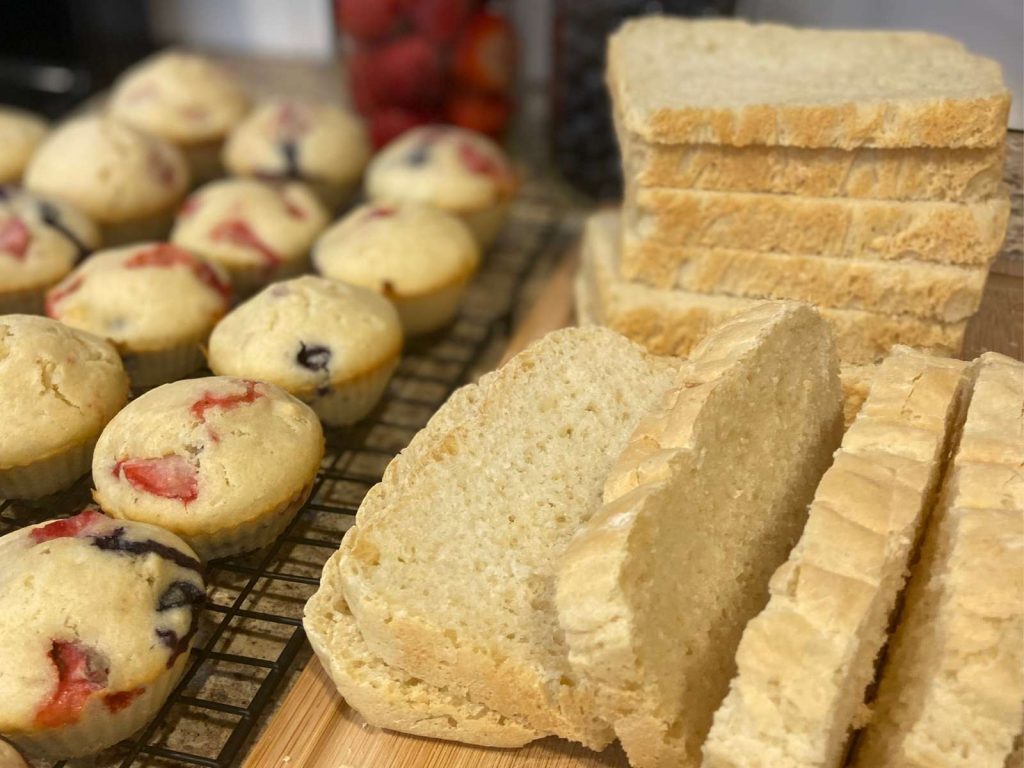 homemade muffins and bread sitting on cooling rack