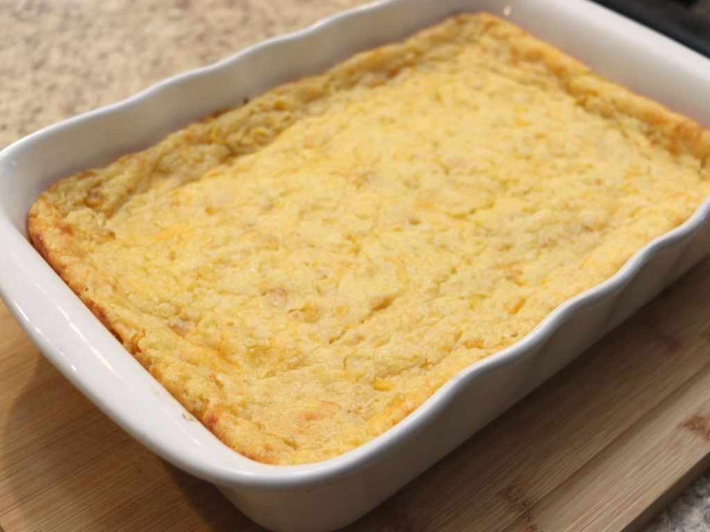 jiffy corn casserole in a white baking dish