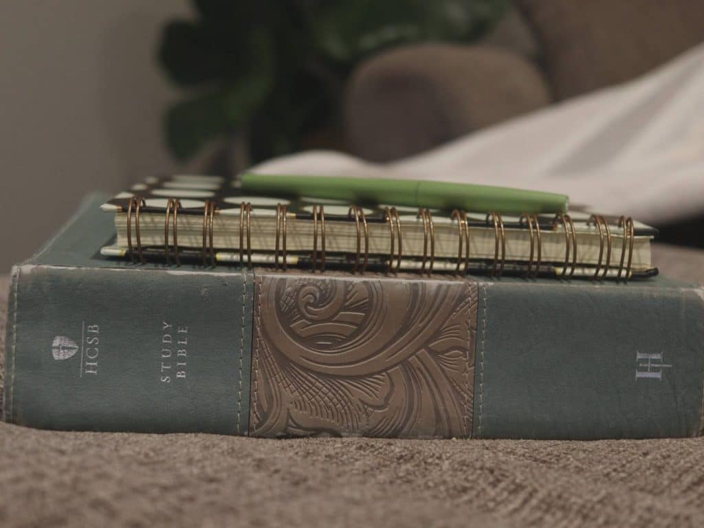 bible, prayer journal, and pen