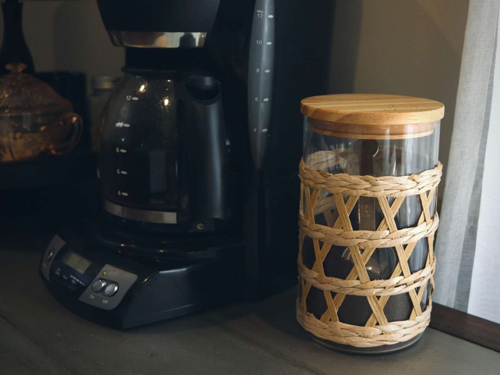 mr. coffee pot with glass jar of coffee grounds