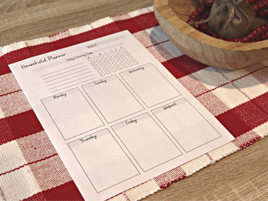 printable household planner sitting on red and white checkered tablecloth