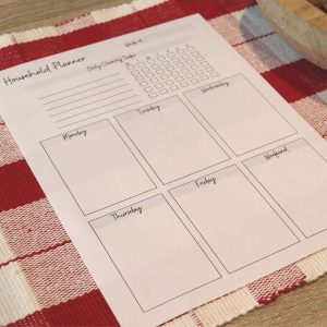 weekly cleaning printable with habit tracker sitting on kitchen table