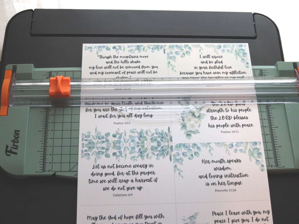 printed scripture cards sitting on a paper cutter