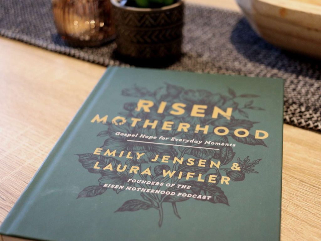 green and gold Risen Motherhood book sitting on kitchen table