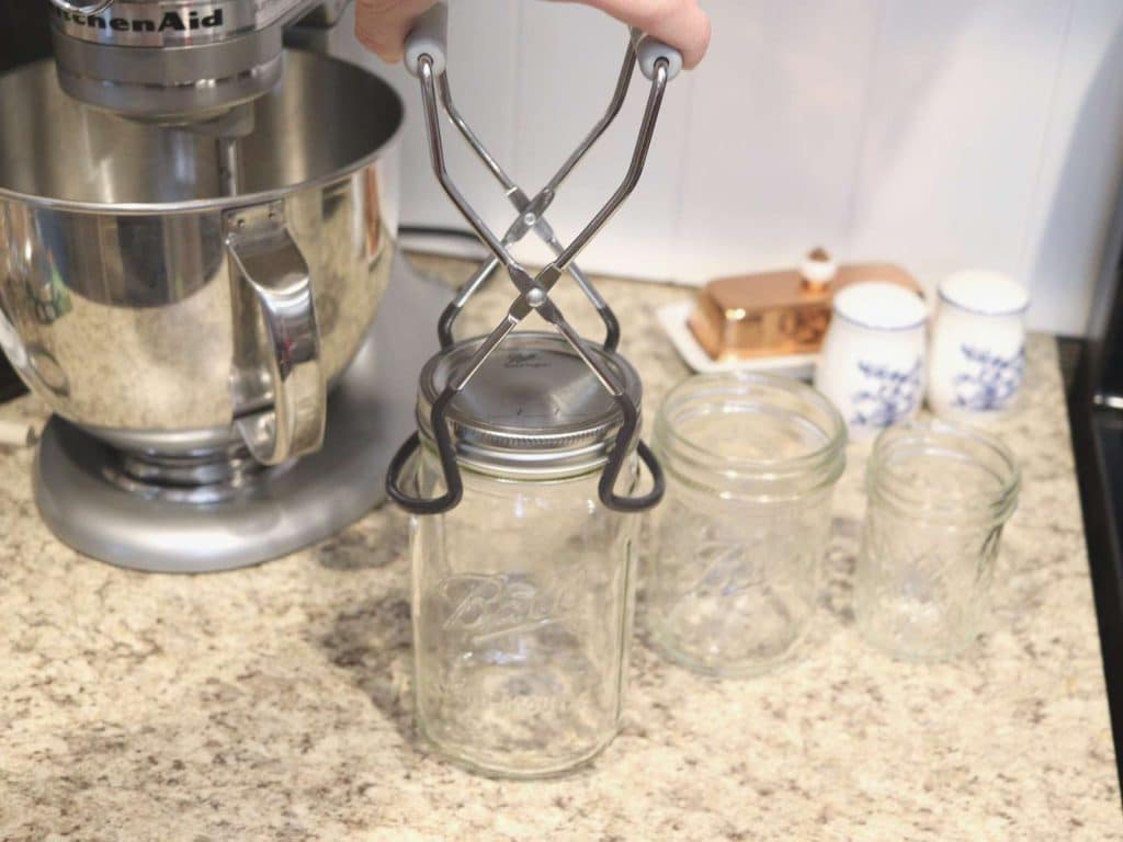 mason jar being lifted up by jar lifter