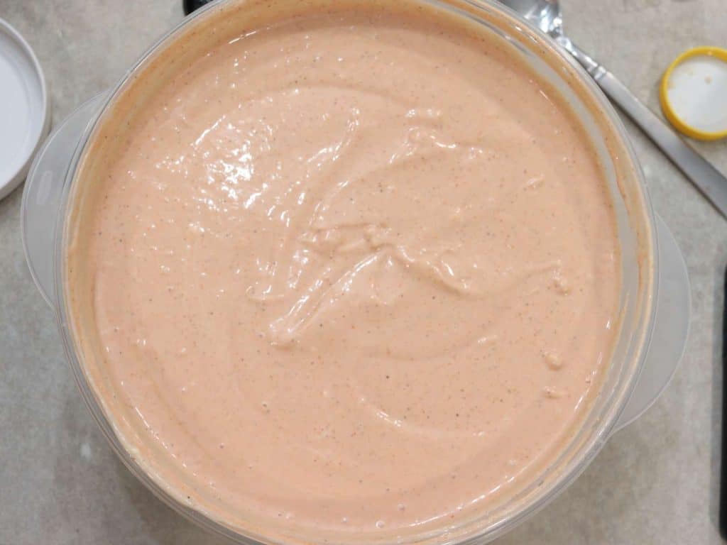 crawfish dipping sauce in large plastic bowl on kitchen counter