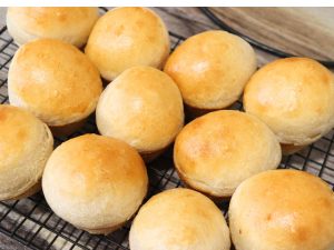 yeast rolls without dairy sitting on top of black wire rack cooling