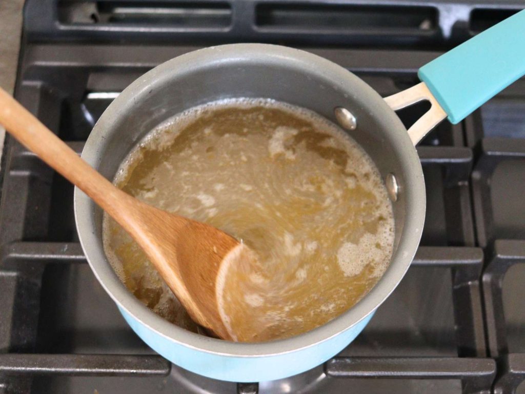 homemade peppermint syrup in a small saucepan on stovetop