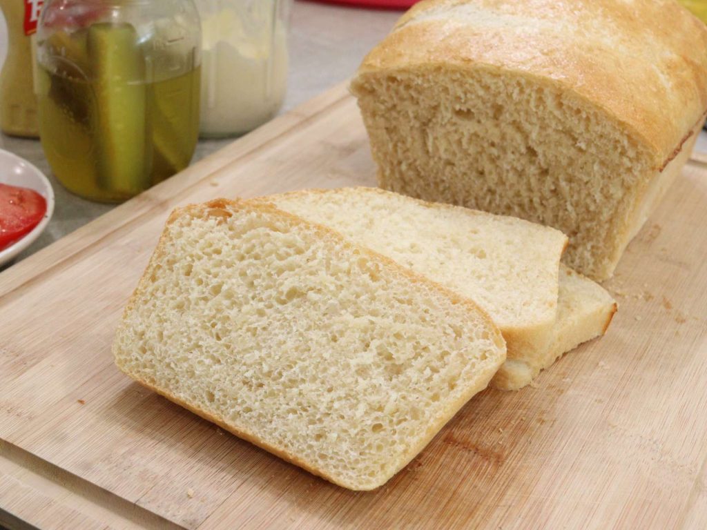 sliced loaf of dairy free sandwich bread on cutting board