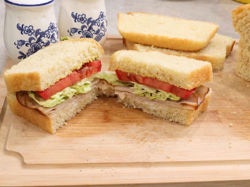 turkey sandwich made with homemade bread on a cutting board