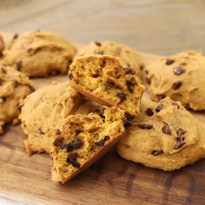soft pumpkin chocolate chip cookies sitting on a cutting board