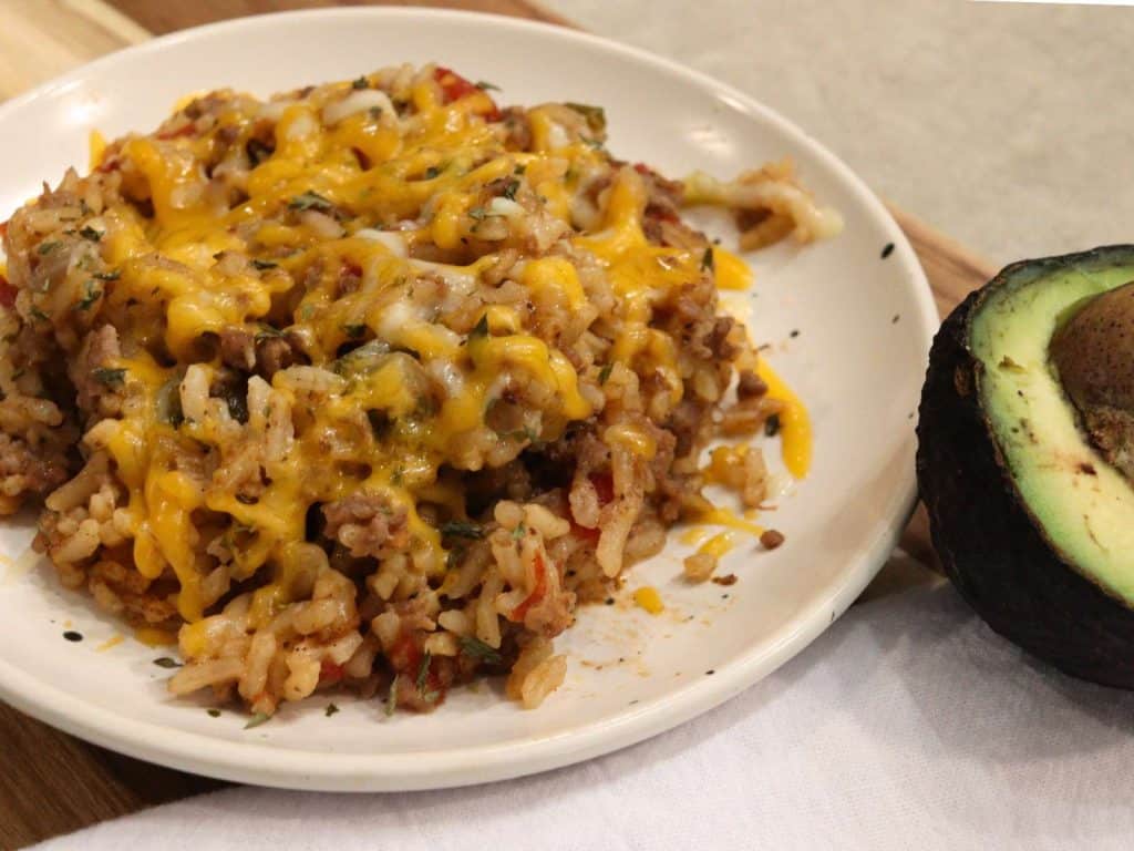 tex mex rice covered with cheese on small plate