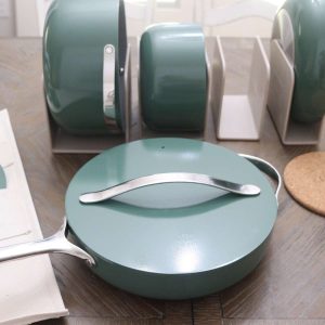 green enamel coated pots and pans from Caraway on kitchen table