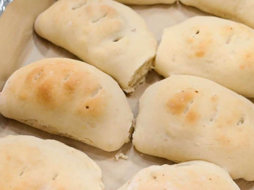 baked breakfast calzones on baking sheet