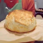 round loaf of homemade bread on parchment paper