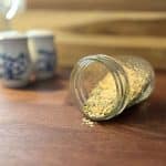 glass jar with seasoning blend sitting on butcher block counter