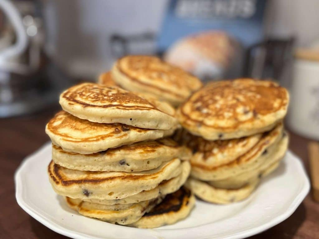 stacks of pancakes sitting on white dish