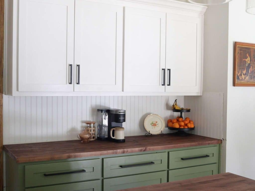 white upper cabinets with green lower cabinets