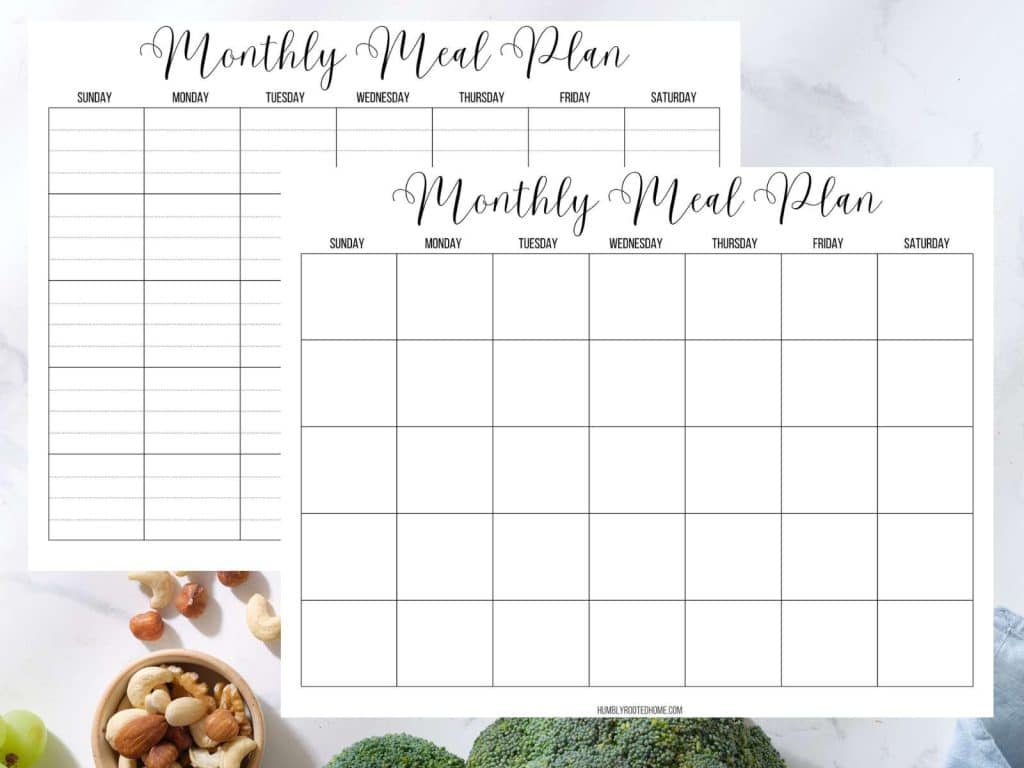 two monthly meal planning calendar pages sitting on kitchen counter