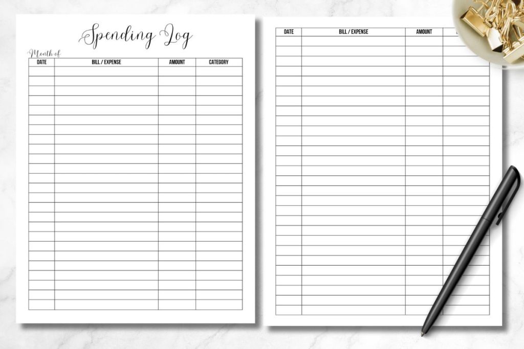 two page spending log on white marble desk