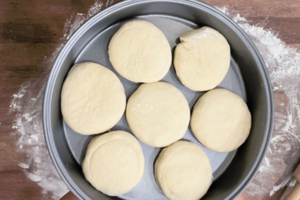 slider buns before baking in a round baking pan