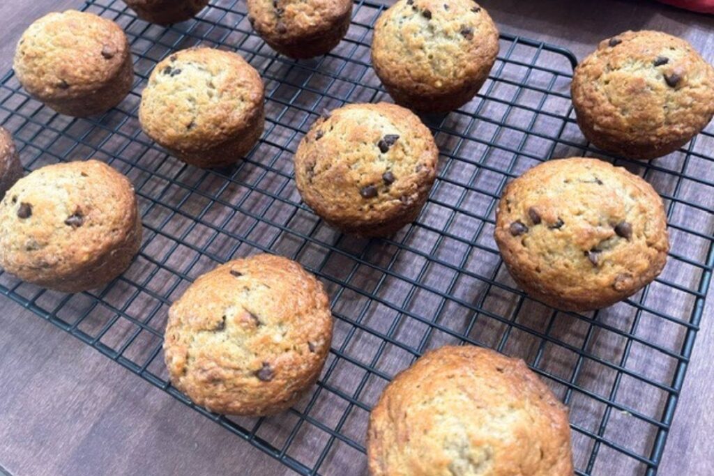 chocolate chip banana muffins sitting on wire baking rack