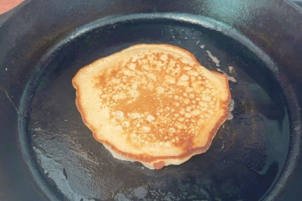 HOMEMADE PANCAKE IN BLACK CAST IRON SKILLET