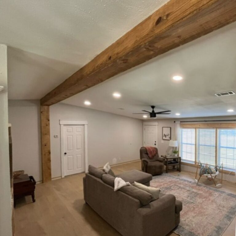 living room in double wide with a wooden beam