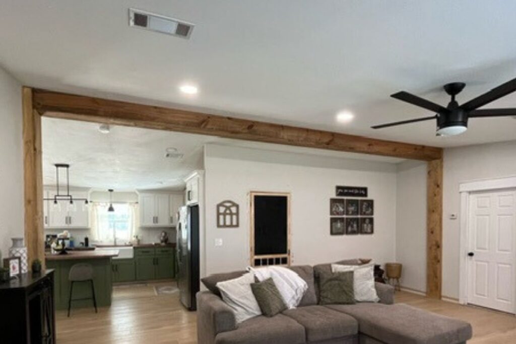 double wide living room with wood beam and luxury vinyl plank flooring