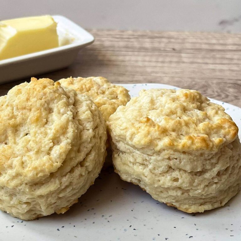 3 buttermilk biscuits sitting on a white plate